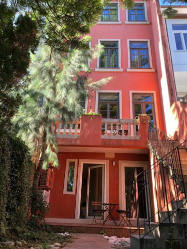 a red building with a balcony in front of it at GR Suites in Porto