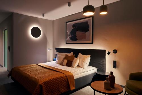 a bedroom with a large bed and a table at Mountains Hotel in Seefeld in Tirol