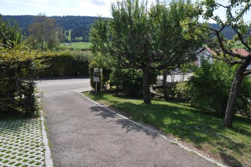 a road with trees on the side of a street at La Ruche in Tramelan