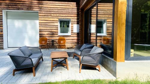 a group of chairs and a table on a patio at Chalupa u Bohumila in Rybná nad Zdobnicí