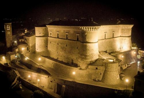 a large castle at night with lights at B&B Fontanelle in Alviano