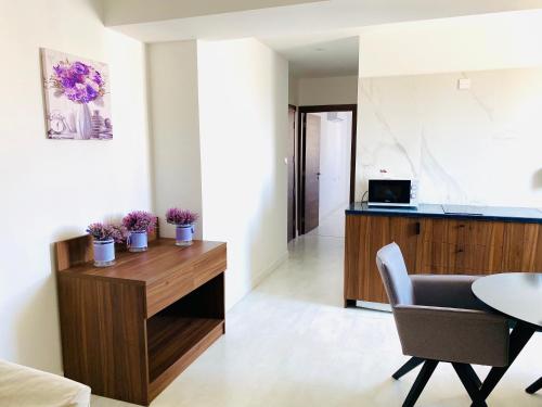 a living room with a table and a dining room at Eleonora Hotel Apartments in Larnaca