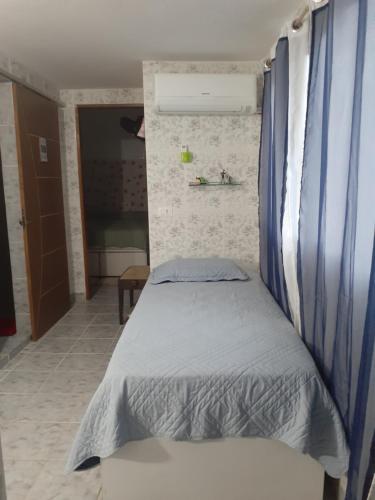 a bedroom with a bed with a blue canopy at Apartamento Centro de Convenções in Recife