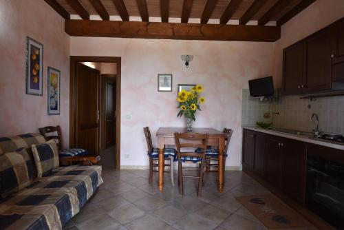a kitchen and dining room with a table and a couch at Agriturismo Corte degli Angeli in Marina di Grosseto