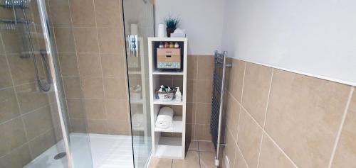 a bathroom with a shower and a glass shower stall at Spacious well equipped Chalet Bungalow close to Nairn, in Auldearn