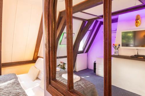 a room with a mirror and a sink in it at Tulip of Amsterdam in Amsterdam