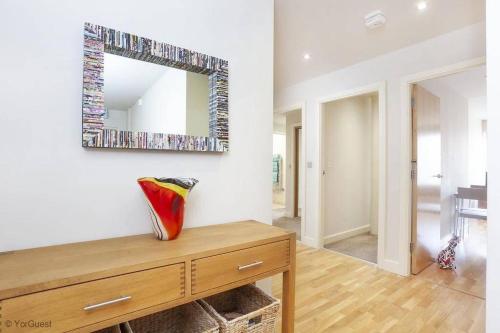 a mirror on a wall above a dresser in a room at Apartment 12 Popeshead Court in York