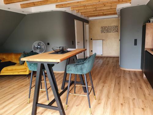 a kitchen and living room with a table and chairs at Moselfeeling co2frei in Cochem