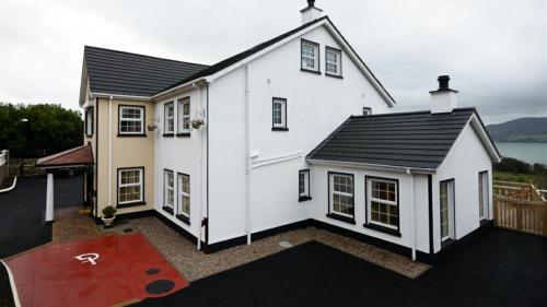 a white house with a red carpet in front of it at Seaview Guesthouse in Rostrevor