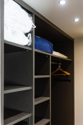 a walk in closet with black walls and shelves at Hotel Rio Bidasoa in Hondarribia