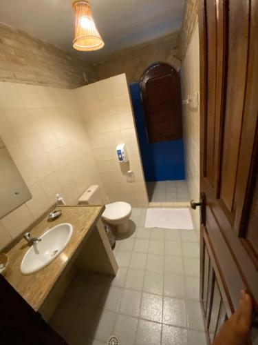 a bathroom with a sink and a toilet at AQUALUNA POUSADA in São Miguel dos Milagres