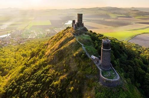 an aerial view of a castle on top of a hill at Cozy wood hut on the farm in Třebívlice