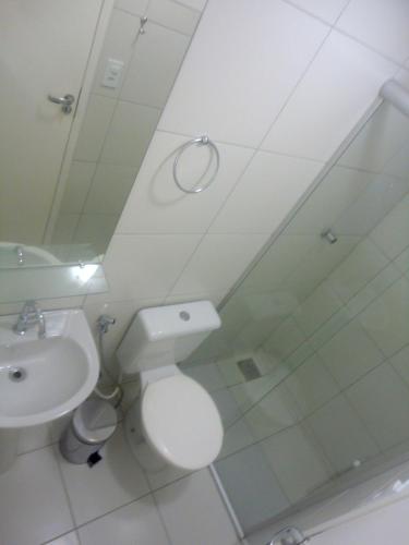a bathroom with a toilet and a sink and a mirror at Hostel Borogodó in Fortaleza