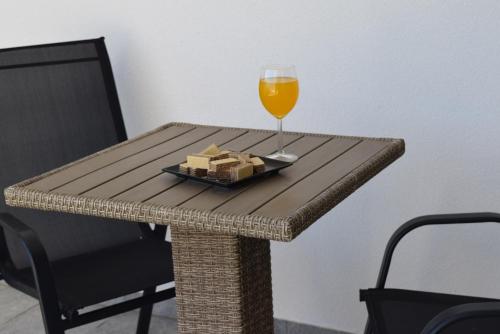 a table with a glass of wine and a plate of cheese at Savršen odmor u Villa Ivona in Zadar