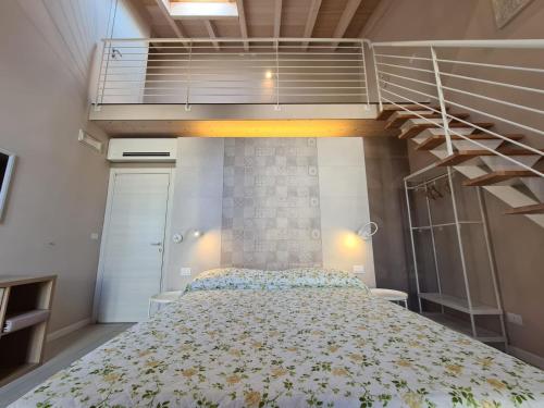 a bedroom with a large bed and a staircase at B&B Locanda de' Colli in Signa