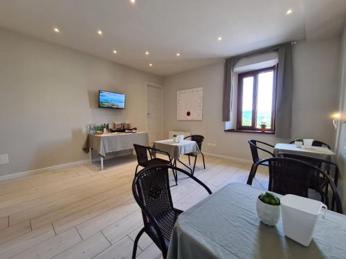 a dining room with tables and chairs and a window at B&B Locanda de' Colli in Signa