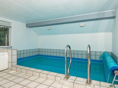 a swimming pool in a house with two faucets at 10 person holiday home in Henne in Henne Strand