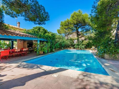 a swimming pool in the backyard of a house at Scenic villa in Martigues with private pool in La Couronne