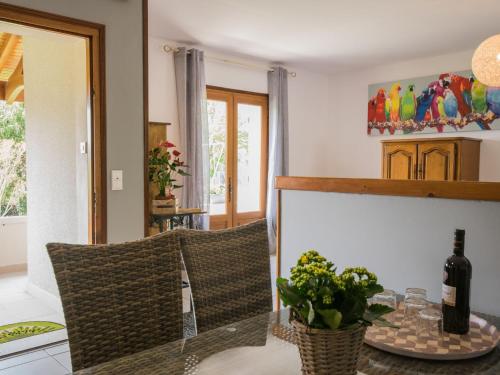 a dining room with a table with a bottle of wine at Heritage holiday home with barbecue in Villefranche-du-Périgord