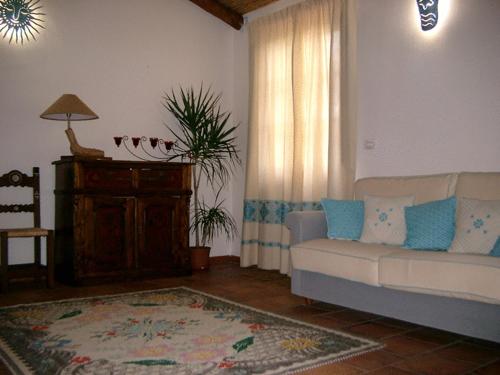 a living room with a couch and a window at Agriturismo nuraghe Putzu Canu in Perfugas