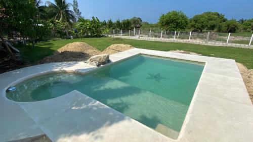 a large swimming pool in a yard with at Puerto Lobos Dive camp in Tamiahua