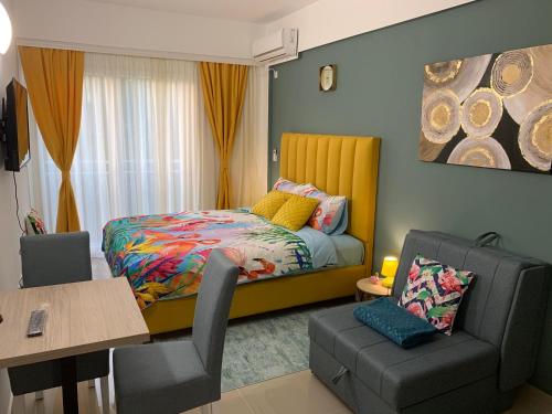a bedroom with a bed and a chair and a table at Sea&Center Lux in Bar
