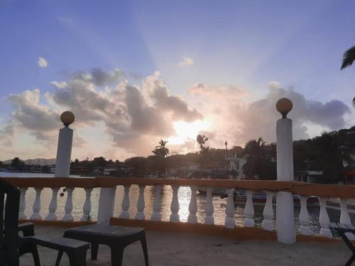 a view of the sunset from the balcony of a resort at Hotel Cocotal in Isla Grande