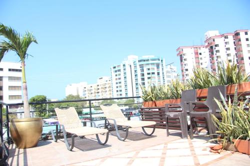 a group of chairs on a balcony with buildings at Hotel Rodadero Dorado in Santa Marta