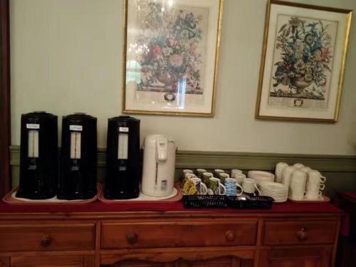 a wooden dresser with three coffee machines on top of it at Braeside Country Inn in Pictou