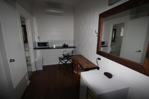 a kitchen with a sink and a counter top at Colonial Rose Motel in Townsville