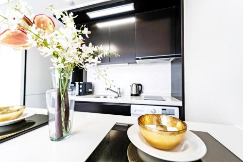 a kitchen with a bowl and flowers on a counter at Hi Ocean Gyeongpo in Gangneung
