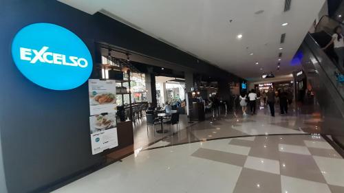 a shopping mall with an exeso sign on the wall at Apartemen Grand Kamala Lagoon Studio By Bonzela Property in Bekasi