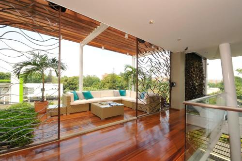 a living room with a couch and a table at AcquaSanta Lofts Hotel in Cali