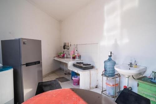 a small kitchen with a sink and a refrigerator at KoolKost Syariah near Stasiun Rawa Buntu (Minimum Stay 6 Nights) in Tangerang