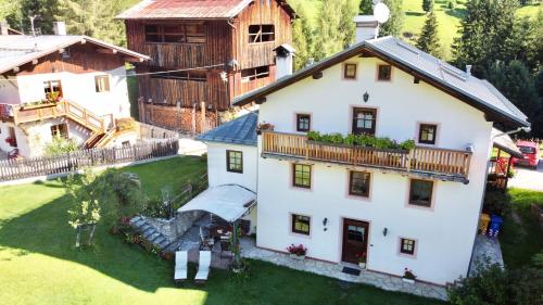 an aerial view of a house with a yard at Dolomites Charme Chalet in Colle Santa Lucia