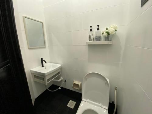 a white bathroom with a sink and a toilet at 118-Nineteen Hideout in Shah Alam