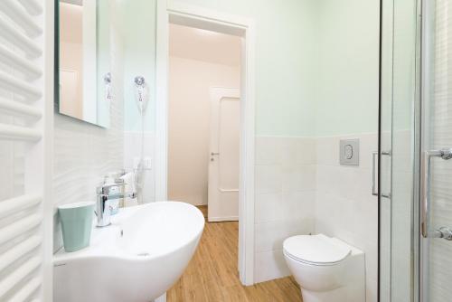 a white bathroom with a toilet and a sink at GUEST HOUSE PIANA DEGLI ALBANESI in Piana degli Albanesi