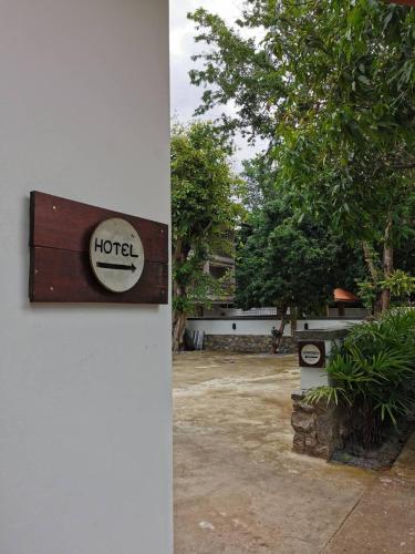 a sign for a hotel on the side of a building at Palin Family Cottage in Chiang Rai
