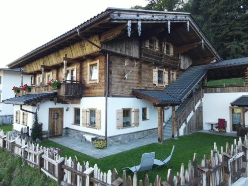 a wooden house with a fence in front of it at Haus Wildschütz in Hippach