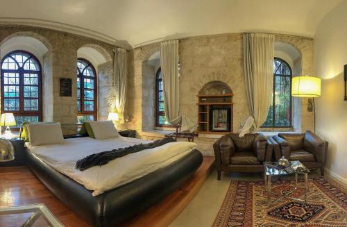 a large bedroom with a large bed and a couch at Alegra Boutique Hotel in Jerusalem