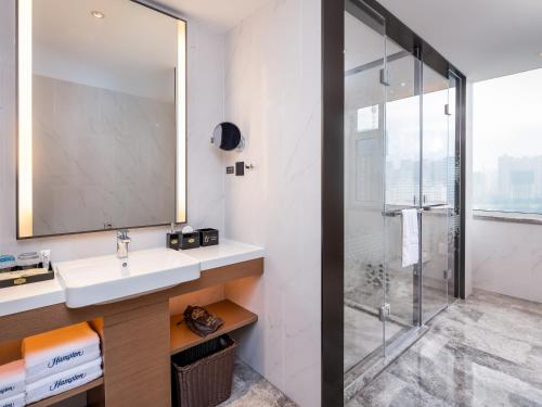 a bathroom with a sink and a shower at Hampton by Hilton Qinhuangdao Jinmeng Bay in Qinhuangdao