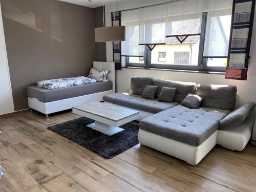 a living room with a couch and a table at Gästehaus Reiger in Wackersdorf