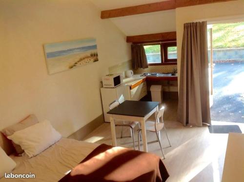 une chambre avec un lit et une table et une cuisine dans l'établissement DOMAINE DE KERIVIN, à Dirinon