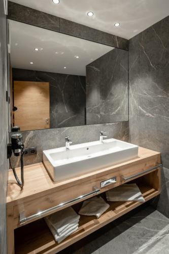 a bathroom with a white sink and a mirror at Der Postwirt in Söll