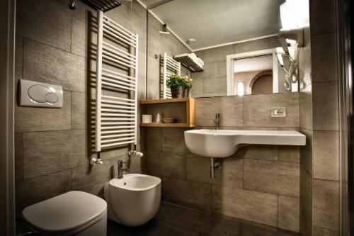 a bathroom with a sink and a toilet and a mirror at Eurohotel in Milan