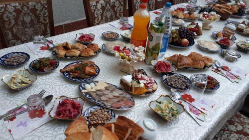 a table with a bunch of food on it at Samani Bukhara in Bukhara