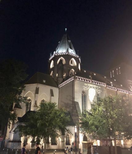 a large building with a clock tower at night at Quai 17 Maison d'hôtes in Strasbourg