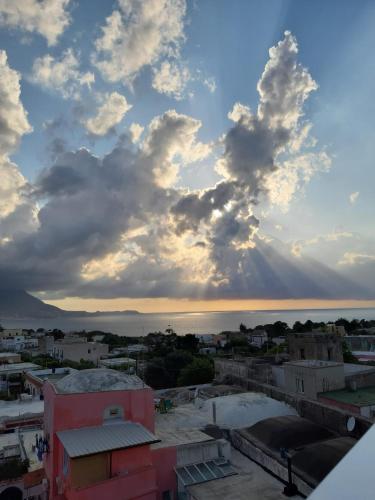 a view of the city with a cloudy sky at Le Volte Procida Home in Procida