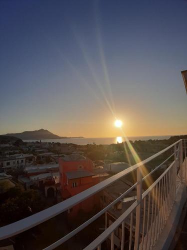 a view of the sunset from the balcony of a building at Le Volte Procida Home in Procida