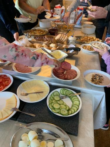 a table with many plates of food on it at Trunna Vandrarhem & Konferens in Orsa